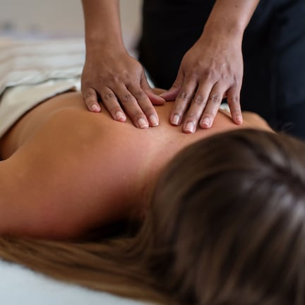 A person receiving a back massage.