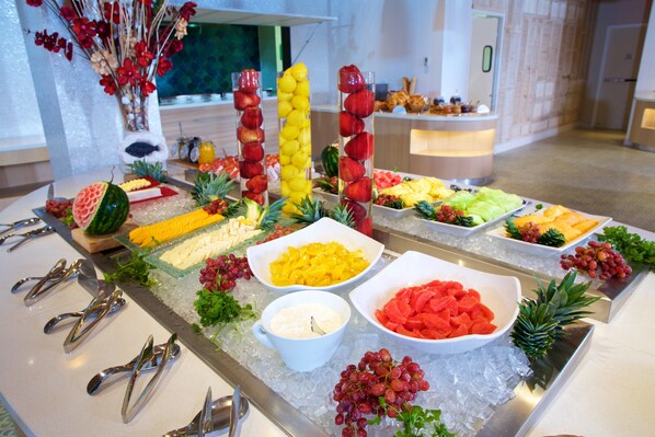 A buffet with various fruits and vegetables arranged on ice. - Warwick Paradise Island- All Inclusive- Adults Only (Paradise Island)