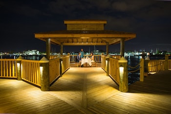 Enjoy dining or relaxing on the deck with a marina view. at Warwick Paradise Island- All Inclusive- Adults Only