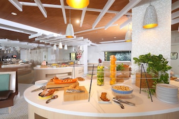 Enjoy a contemporary dining experience with a central island buffet and pendant lighting. at Warwick Paradise Island- All Inclusive- Adults Only