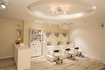 Relax in a stylish room with a central seating area, reception desk, and shelving unit. at Warwick Paradise Island- All Inclusive- Adults Only