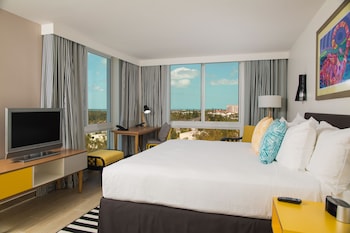 Enjoy a comfortable stay with a large bed, flat-screen TV, and city views from the large windows. at Warwick Paradise Island- All Inclusive- Adults Only