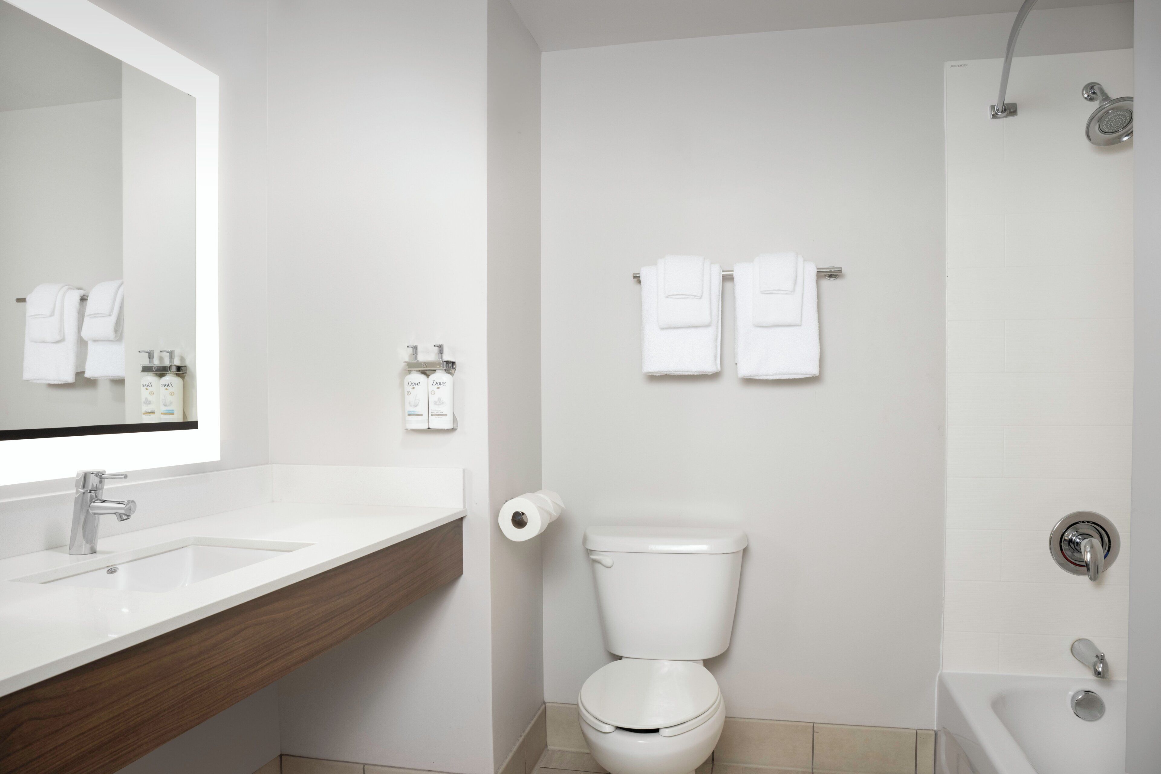 A modern bathroom with a sink, toilet, and shower.