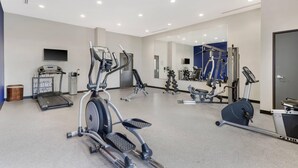 A gym with treadmills, elliptical machines, and weight equipment. - Comfort Inn & Suites (Claremore)