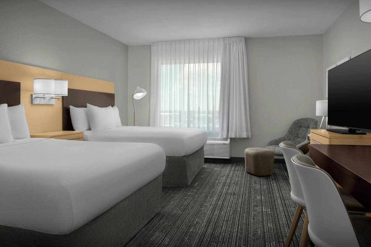 Premium bedding, desk, laptop workspace, blackout curtains