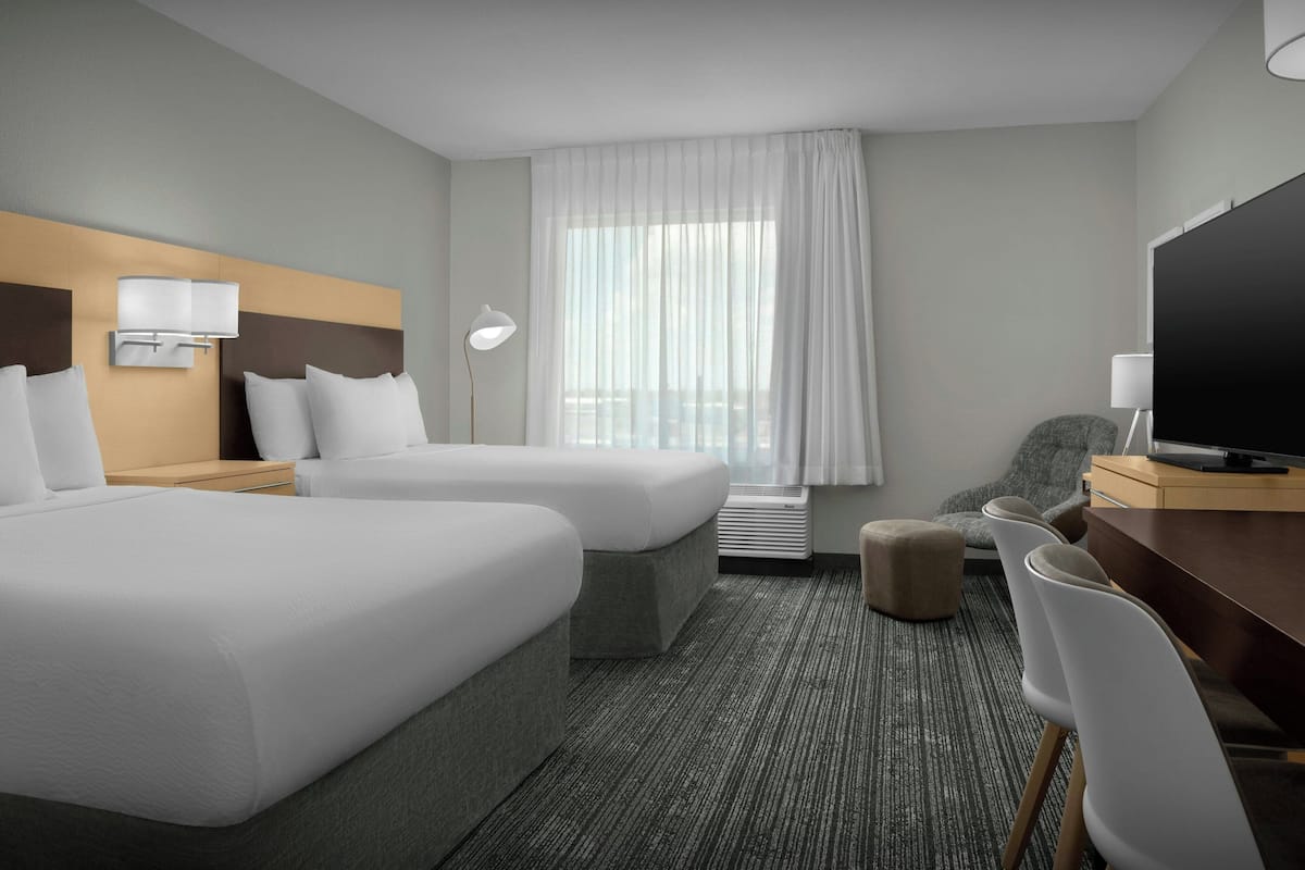 Premium bedding, desk, laptop workspace, blackout drapes