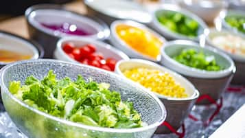 A variety of food items in bowls, including salads and other dishes.