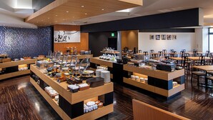 A modern cafe with multiple serving stations, wooden furniture, and a patterned wall. - Niigata Daiichi Hotel (Niigata)
