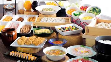 A variety of food items including sushi, bowls of soup, and a pot of rice.