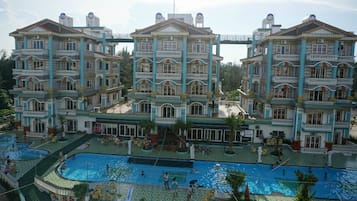 Experience the hotel's unique architecture and unwind in the central courtyard, where multiple pools and lounge chairs await.