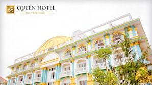 A large, multi-story hotel with a prominent yellow dome and balconies.
