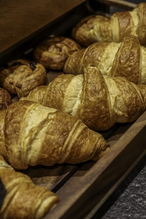 A tray of assorted pastries, including croissants and chocolate-covered items, likely in a bakery or café setting. - Mercure Belfort Centre (Belfort)