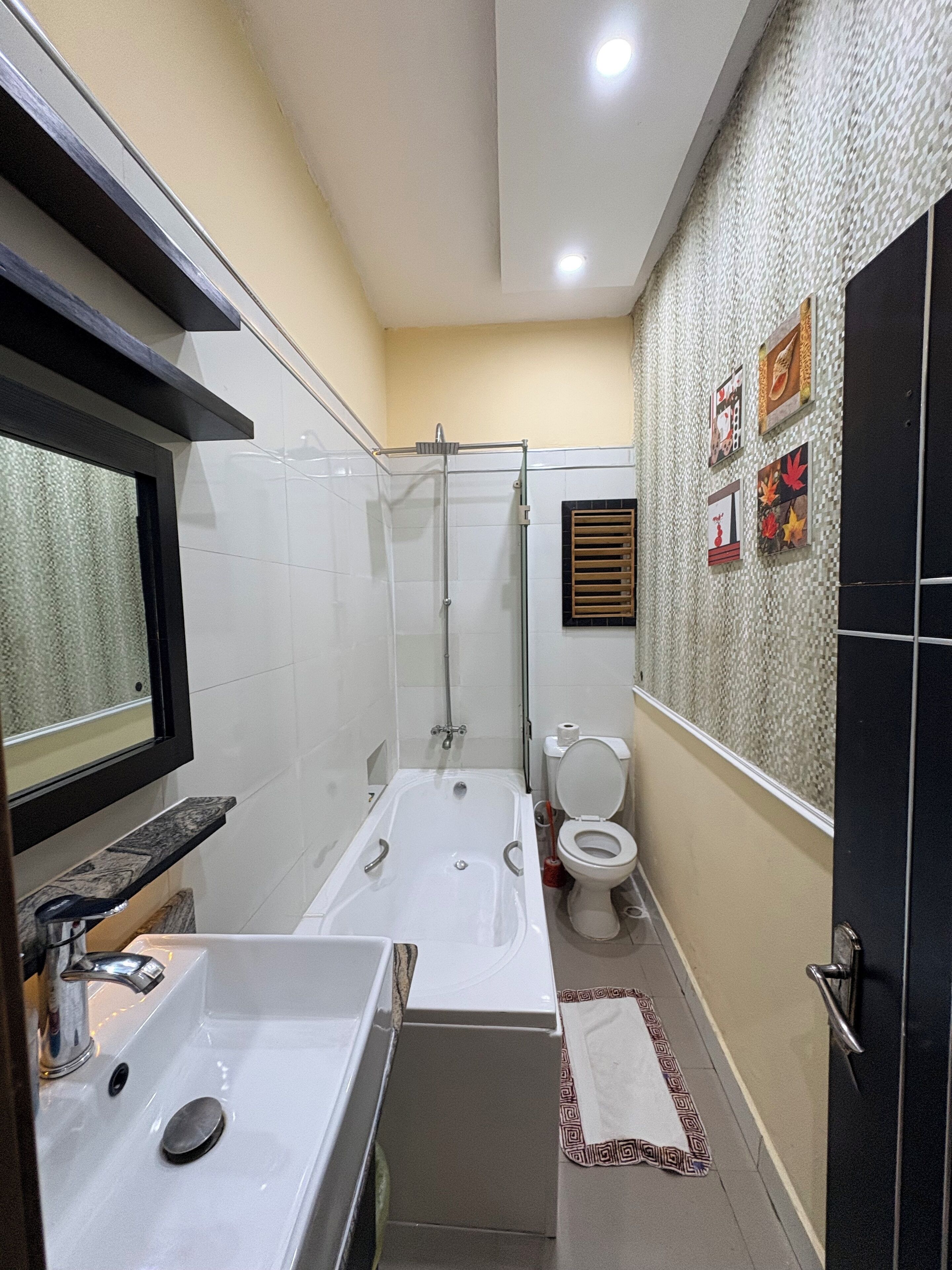 A bathroom with a bathtub, a toilet, and a sink.