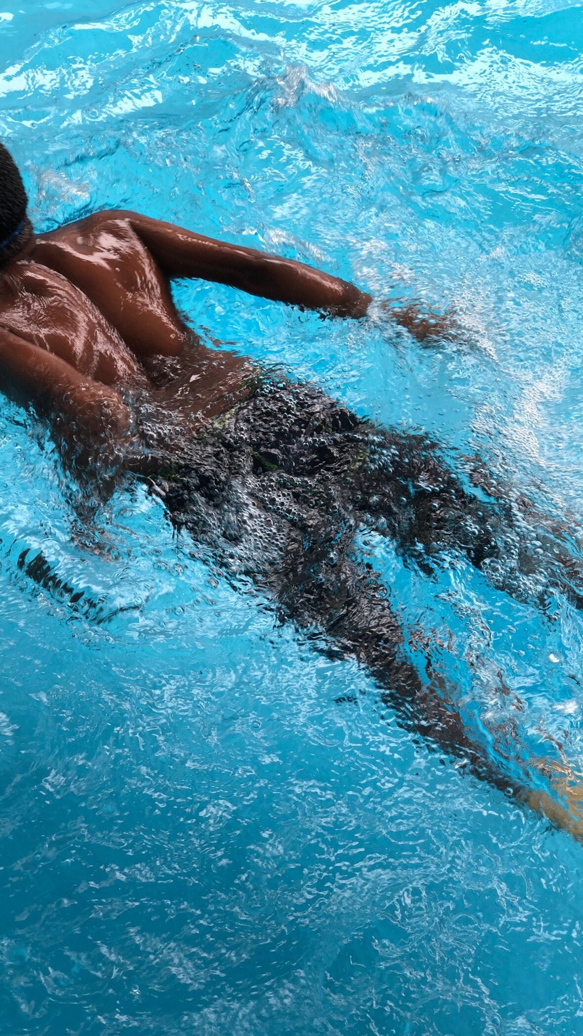 A person swimming in a pool.