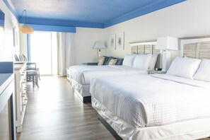 A hotel room with two beds, a dining area, and a view of the sea. - Surf Side Hotel (Nags Head)