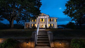 A large, two-story building with a symmetrical facade, a central entrance with steps, and a flagpole. - Steeles Tavern Manor (Raphine)