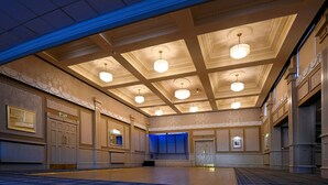 A spacious hotel lobby with a high ceiling, multiple chandeliers, and a checkered floor. - Corner House Hotel (Annan)