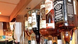 A bar with multiple liquor bottles displayed on shelves. - The Village Inn and Kirtle House B&B (Lockerbie)