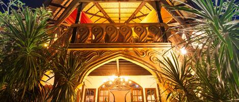 A building with a wooden facade, a central staircase, and a glass ceiling.