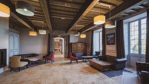 A spacious lobby with a high ceiling, exposed wooden beams, and large windows. - Château de Loubéjac (L'Honor-de-Cos)