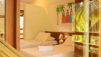 A hotel room with two beds, a large window with a view of palm trees, and a painting on the wall.