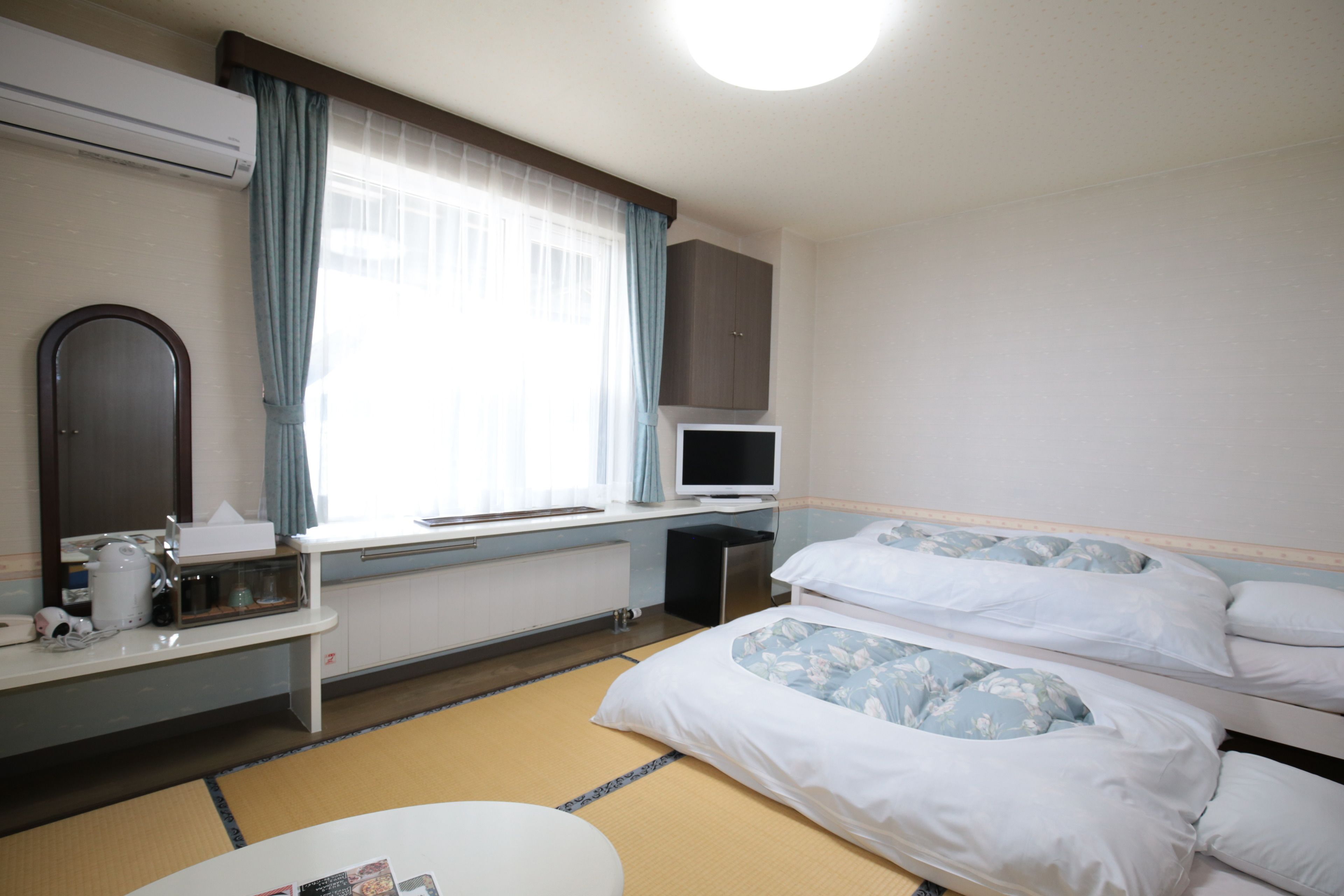 twin room with partial sea view | down duvets, desk, blackout curtains, iron/ironing board