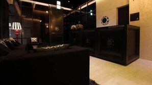 A modern interior with a sofa, lamps, and a wall labeled "INFORMATION". - Sota Stay Gundae (Seoul)