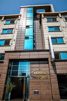 A building with a sign reading "Hilton Park" and a number "49" on the facade.
