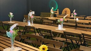 An indoor venue with wooden tables and chairs, decorated with small potted plants and vases. - Stay Pohang Hotel (Pohang)