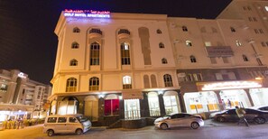A hotel with a prominent sign indicating it is a self-contained hotel with apartments.