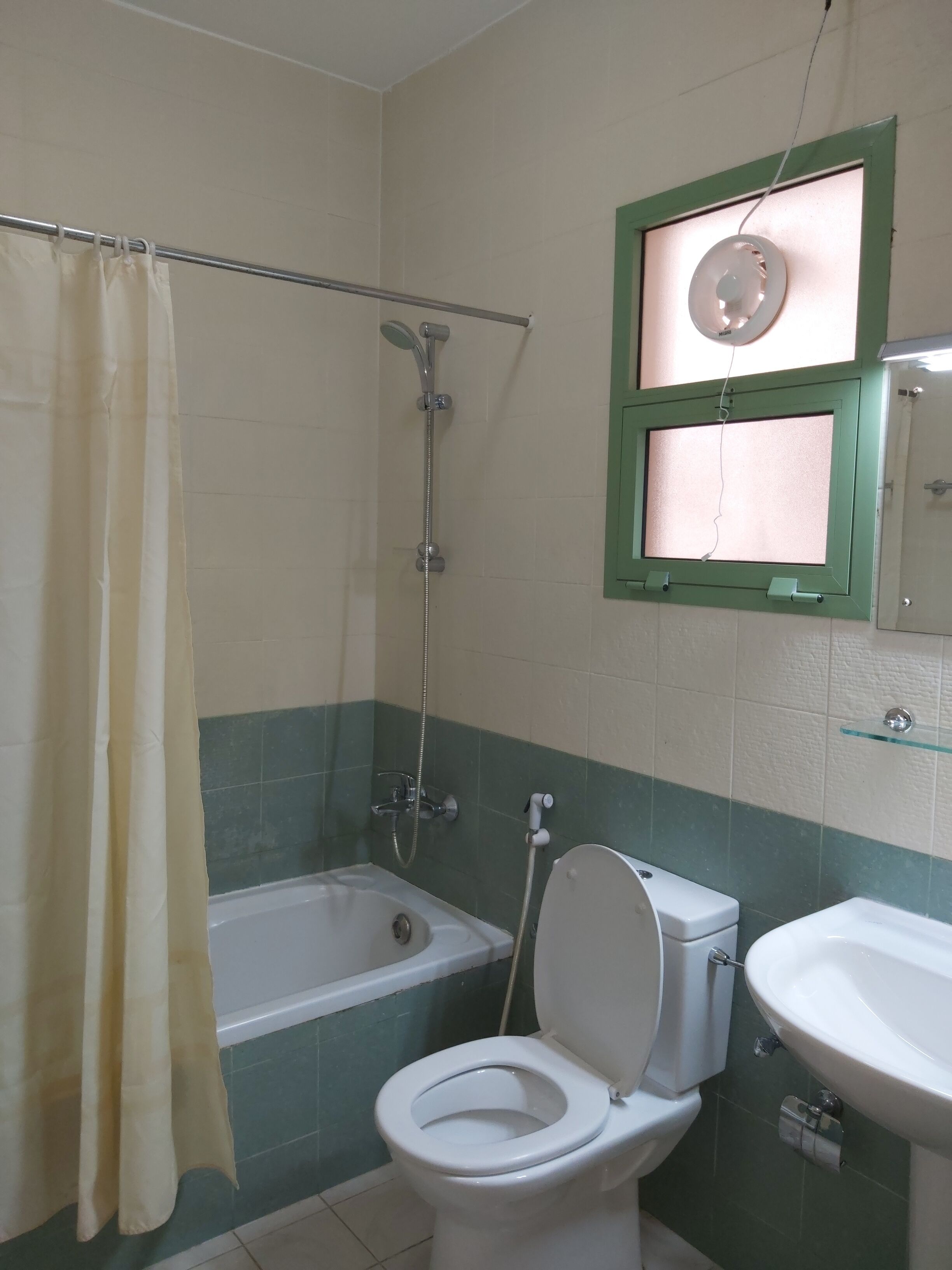 A bathroom with a bathtub, toilet, and sink.