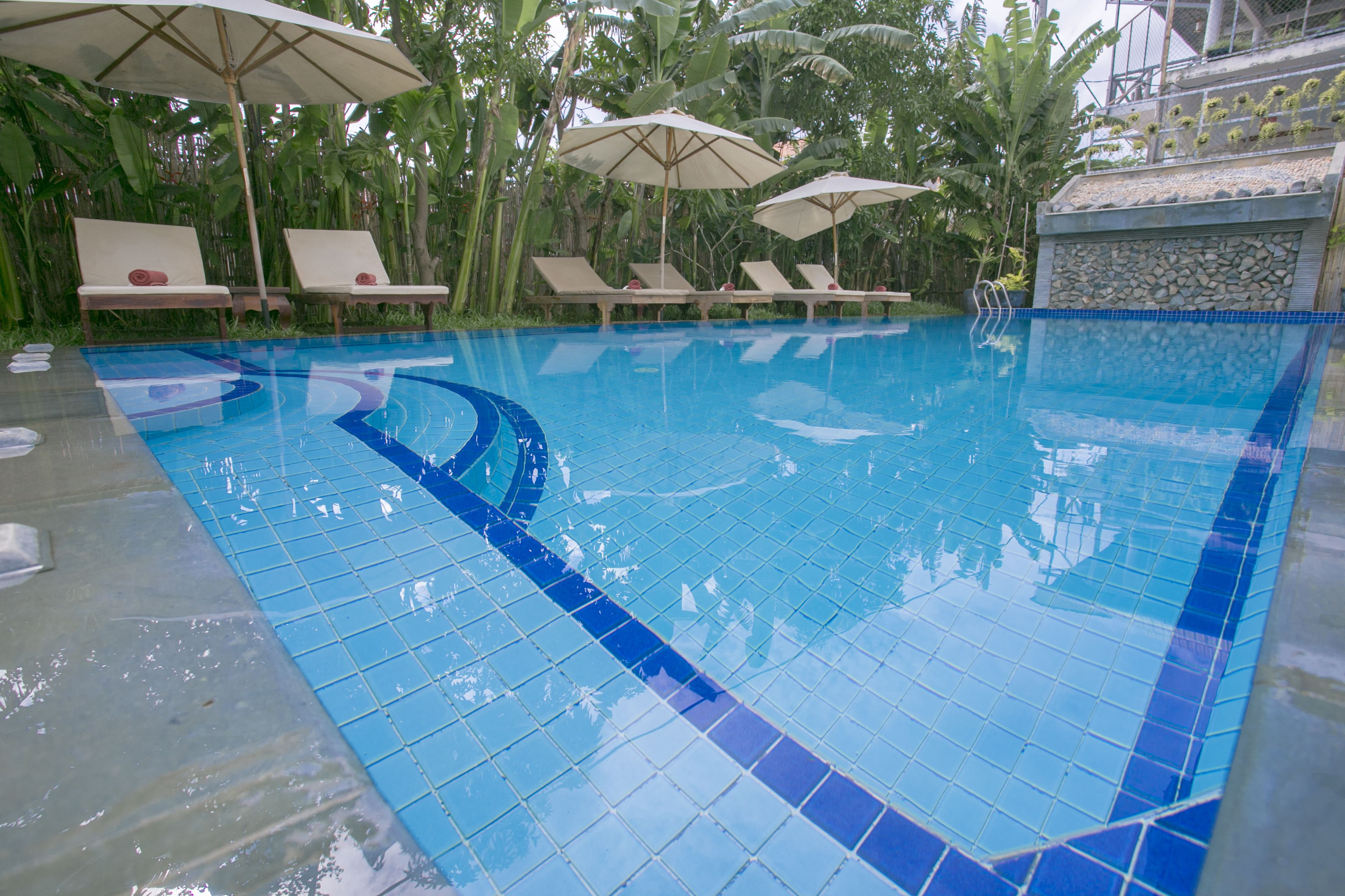 Outdoor pool, open 6 AM to 9 PM, pool umbrellas, pool loungers
