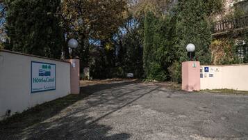 A gated entrance to a hotel with a sign indicating private parking.