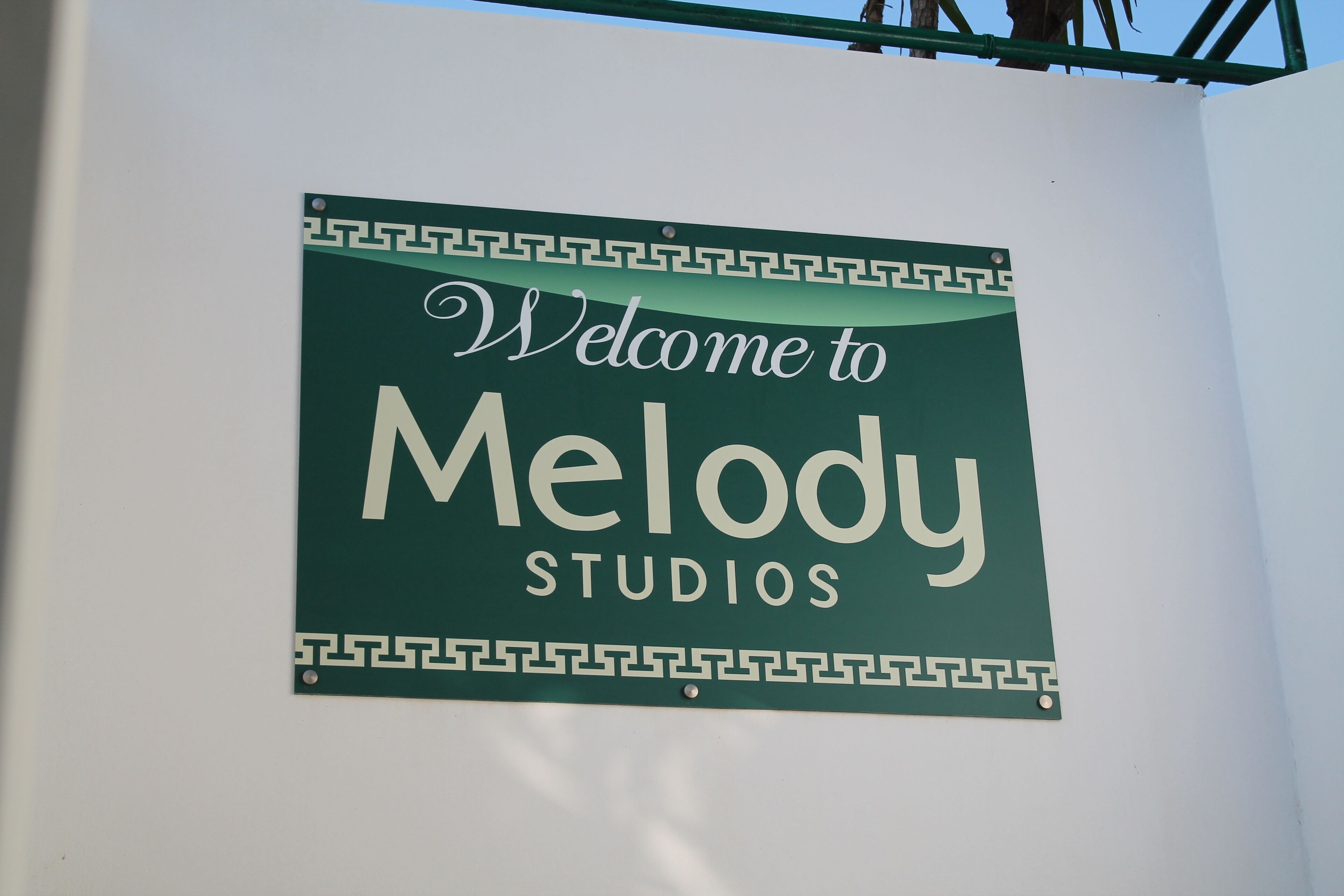 A sign with the text "Welcome to Melody Studios".