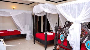 A room with two beds, each with a canopy, white bedding, and red accents. - Forodhani Park Hotel (Zanzibar Town)
