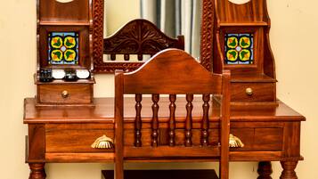A wooden dresser with a mirror, drawers, and two decorative glass panels.