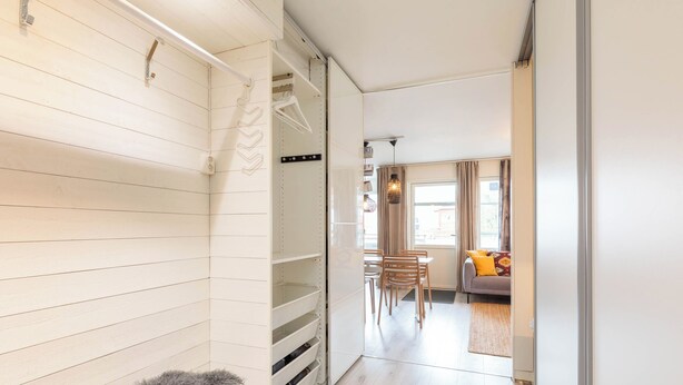 A hallway with a wooden floor leading to a living area with a sofa and chairs. - Åre Travel - Center (Are)