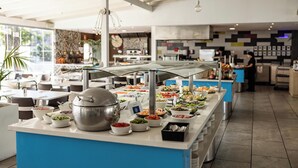 A buffet area with various food stations and a chef preparing food in the background. - Servatur Playa Bonita (San Bartolomé de Tirajana)