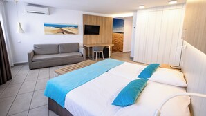 A hotel room with a bed, a sofa, a desk, and a TV. - Servatur Playa Bonita (San Bartolomé de Tirajana)