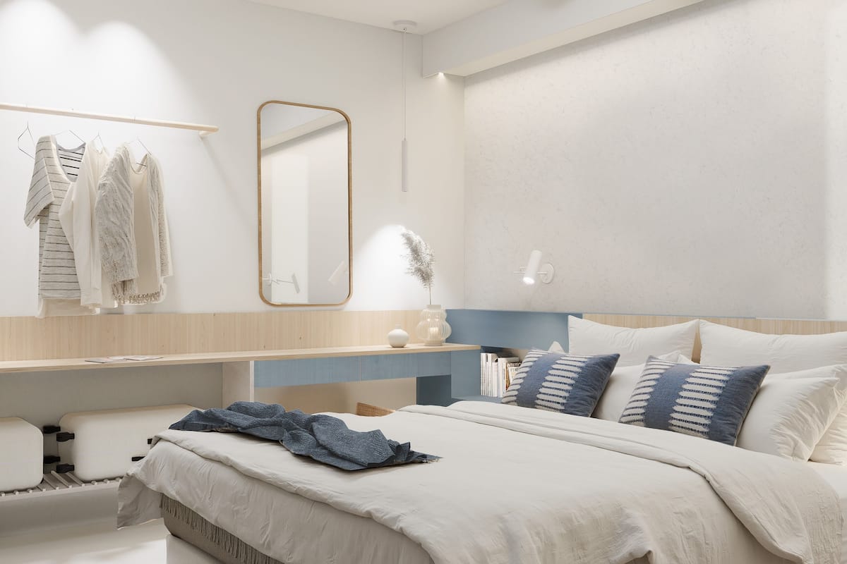 Une chambre à coucher moderne avec un lit, des tables de chevet, un miroir et une armoire.