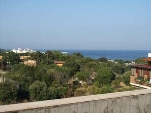 A coastal residential area with houses surrounded by greenery and a view of the sea. - Comeinsicily - Rocce Nere (Giardini Naxos)
