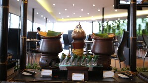 A display of traditional food items, including a central pot and two smaller pots, with labels indicating 'Singkong Rebus' and 'Pisang Rebus'. - Hotel Aria Gajayana Malang (Malang)
