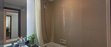 A modern bathroom with a bathtub, a sink, and a shower.