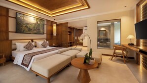 A modern hotel room with a large bed, a sofa, a round wooden table, and a TV. - Anumana Ubud Bali (Ubud)