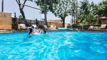Seasonal outdoor pool, open 10:00 AM to 7:00 PM, pool loungers