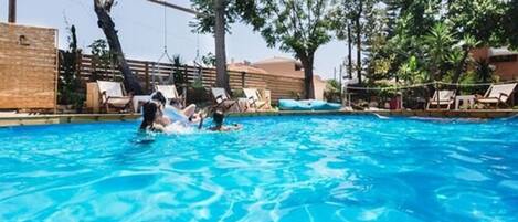 Seasonal outdoor pool, open 10:00 AM to 7:00 PM, pool loungers