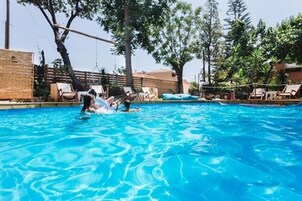 Seasonal outdoor pool, open 10:00 AM to 7:00 PM, sun loungers