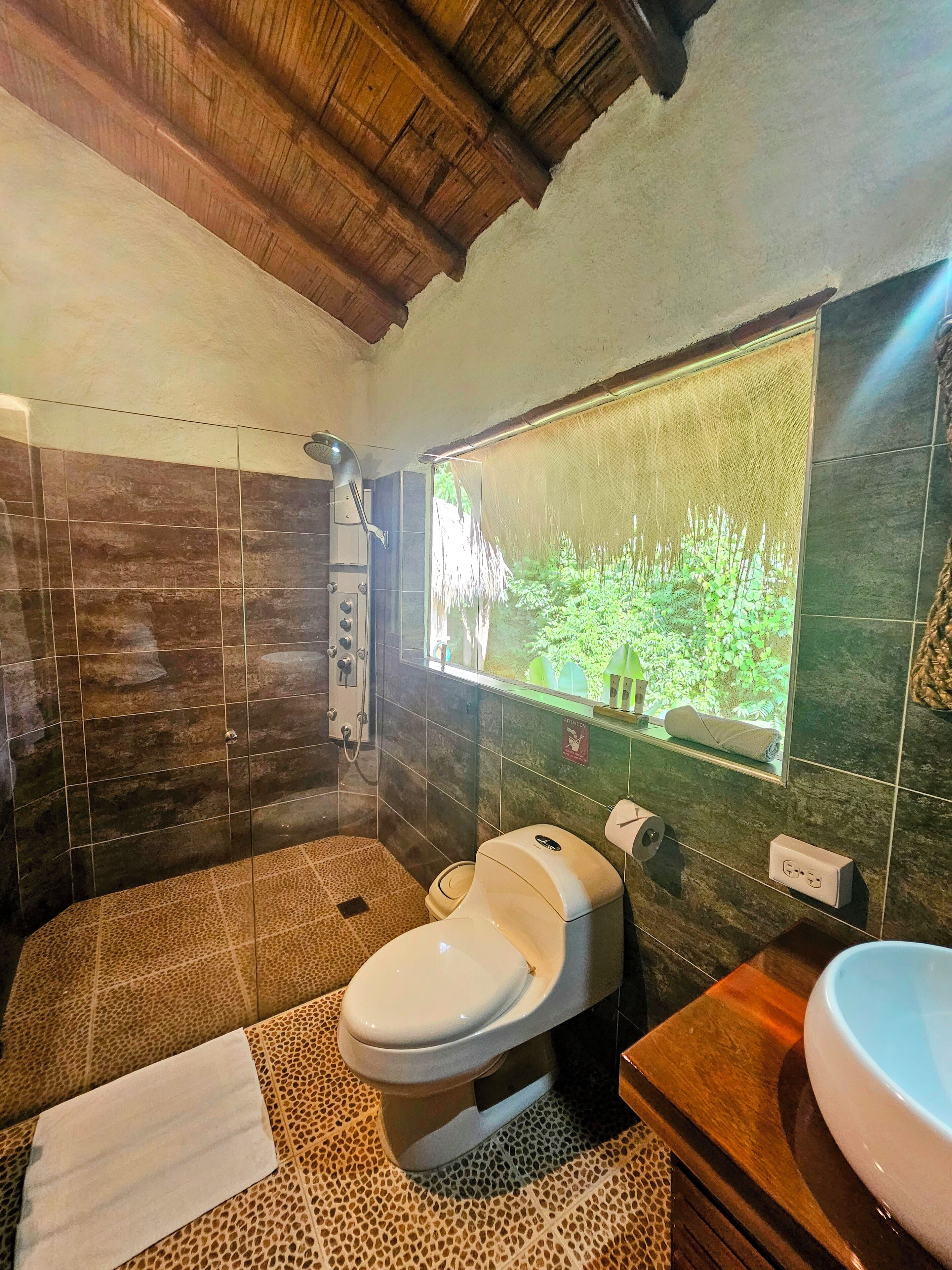 deluxe room | bathroom | shower, rainfall showerhead, free toiletries, hair dryer