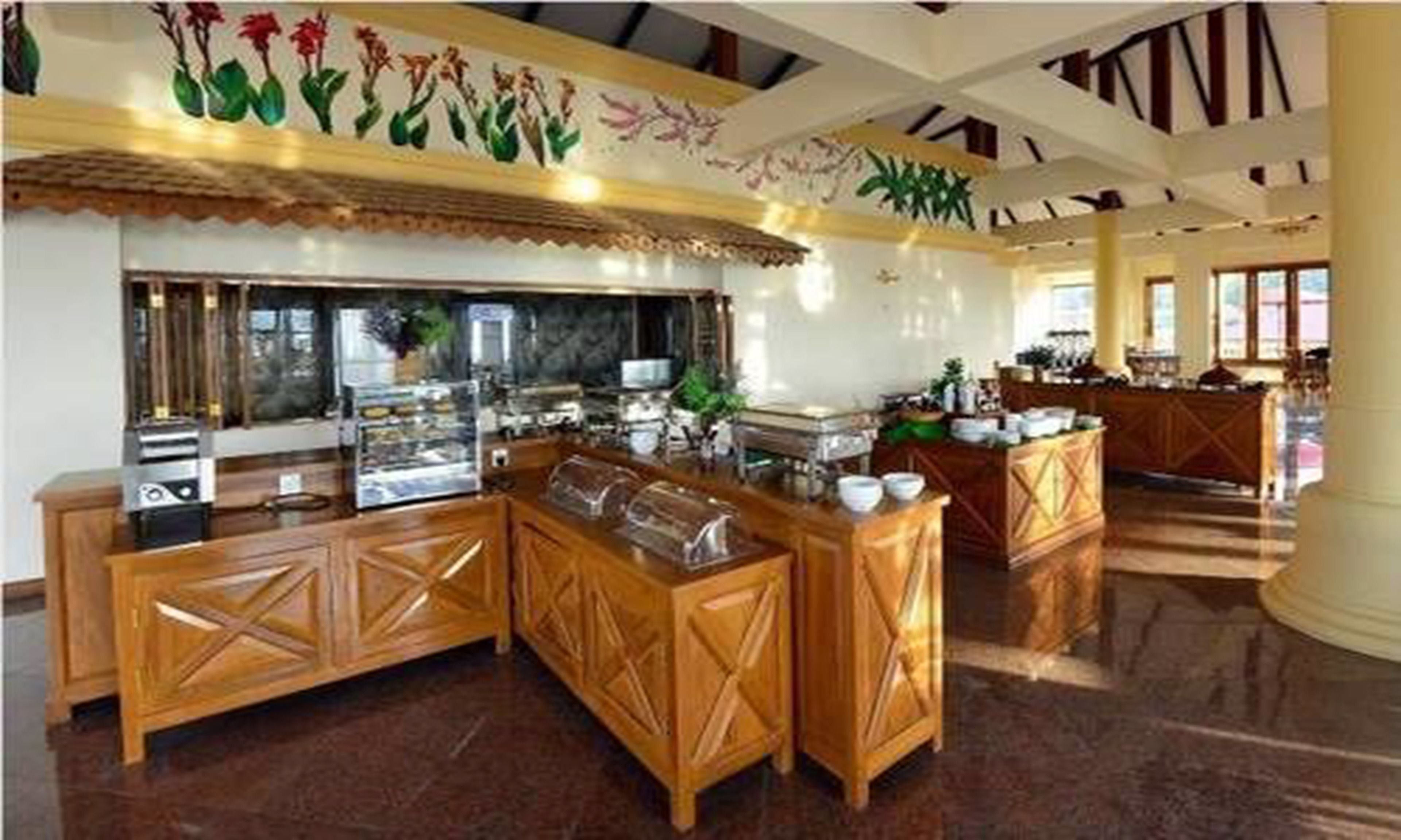 A restaurant with wooden counters and a decorative ceiling.