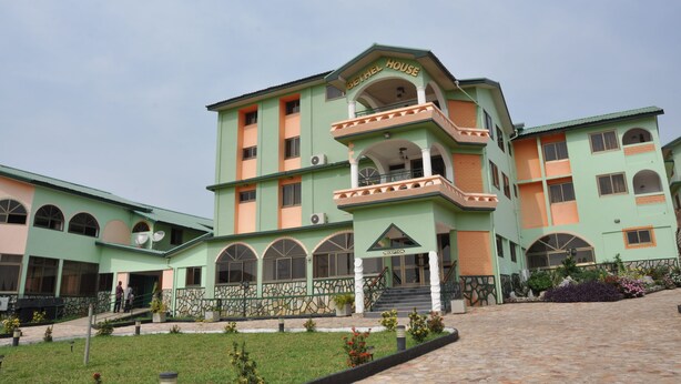 A multi-story building with a reception area and a balcony.